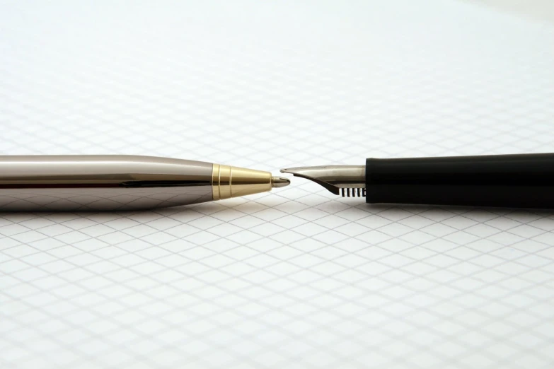 two pens on top of a blank paper