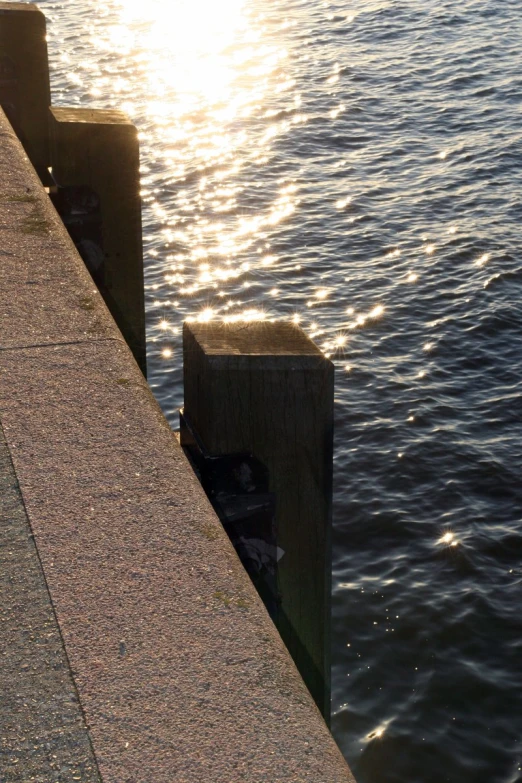 a dock with sunlight shining in the water