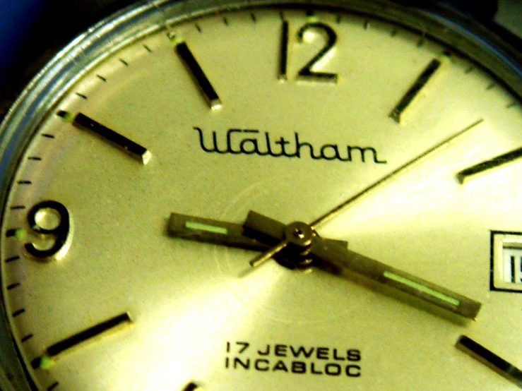 a watch with a date on it and gold dials