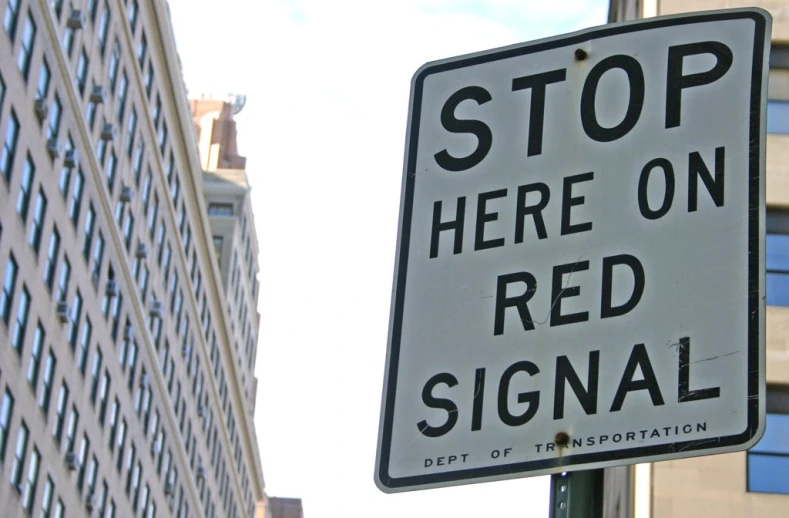 there is a stop sign for red signal at the corner