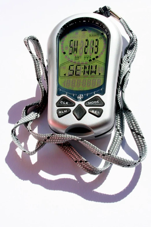 a white digital alarm clock laying on top of a table