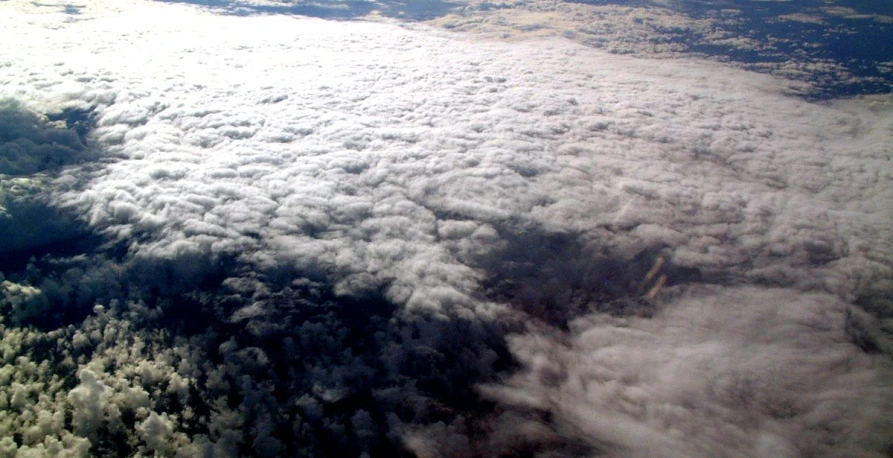 the view from an airplane shows some clouds