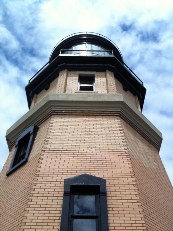 the top of a brick building with a black shutter open