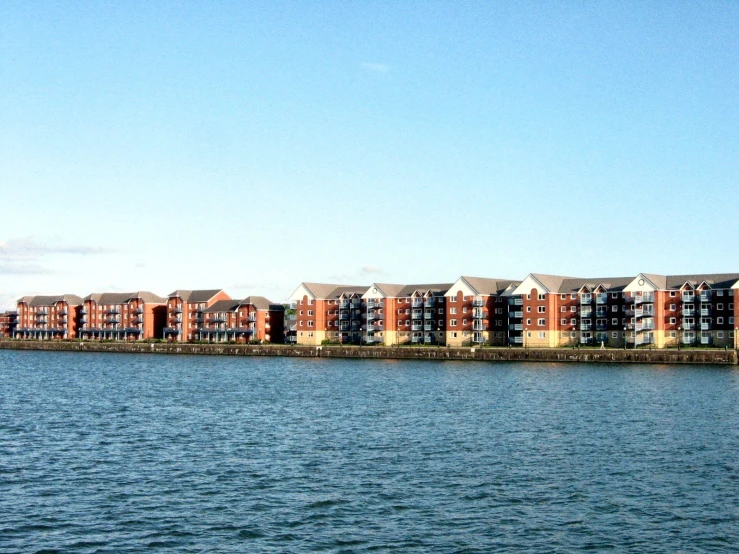 a row of buildings sitting along the side of a lake