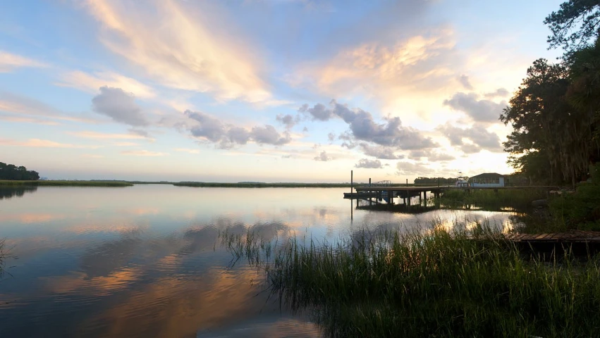 a po of water and a boat at dusk