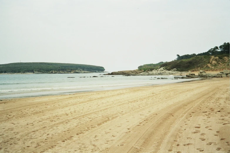 the beach is covered with footprints and sand