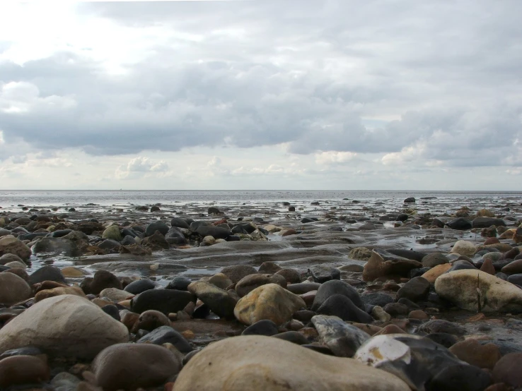 rocks and stones with water in the background