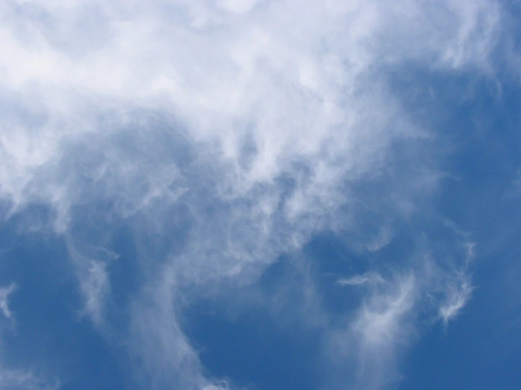 an airplane in the sky on a sunny day