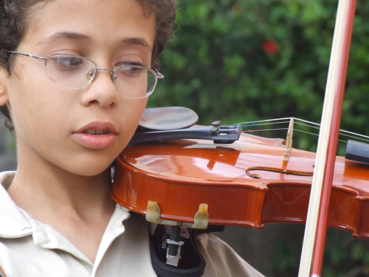 a  with glasses, holding up his violin