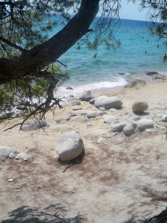 rocks on the beach, a small wave breaks in