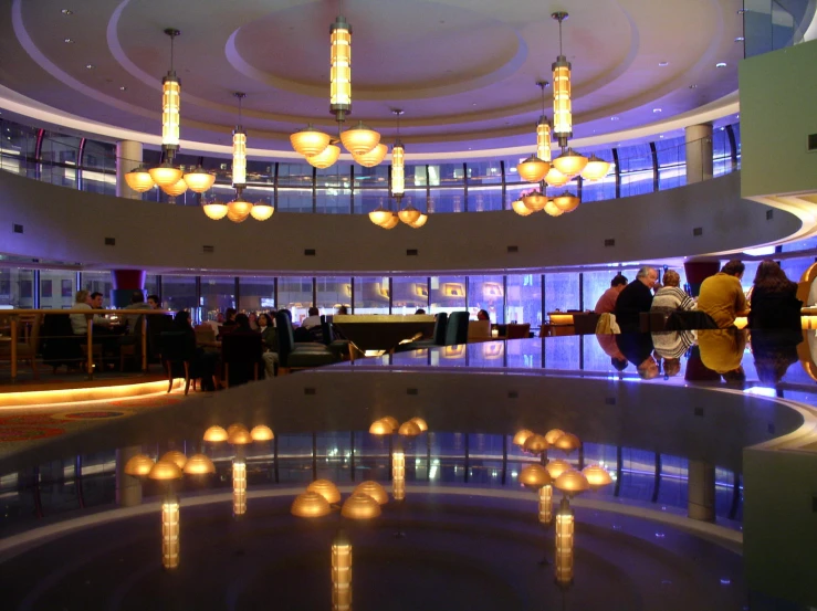 the lobby of an office building with people milling around the place