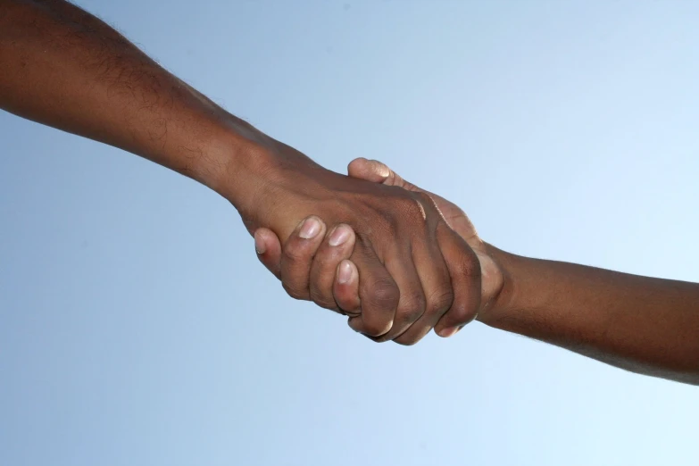 a couple of people holding hands over one another