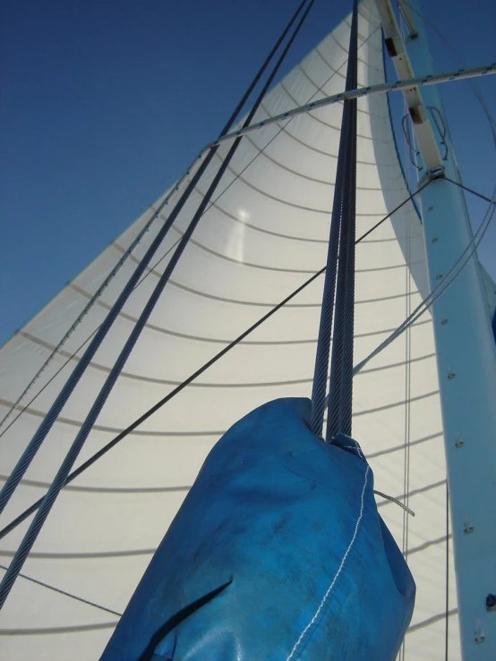 the sail being carried on to a boat for repair