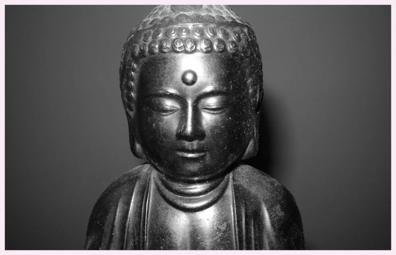 a silver buddha statue with the words there is no god in this picture