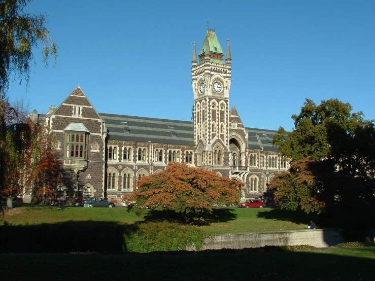 an old building with a clock tower next to trees