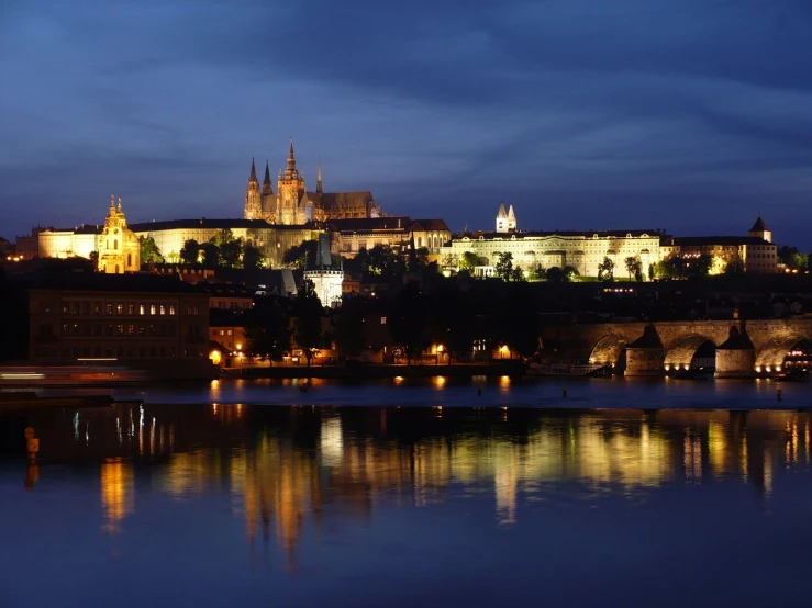 a large castle on the side of a river