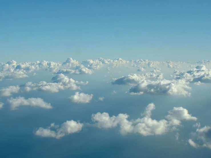 there is a plane flying above the clouds