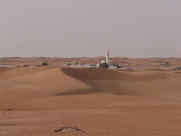 a sand dune with a very large tower on it