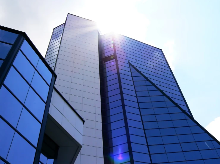 the top portion of two skyscrs are visible against a blue sky