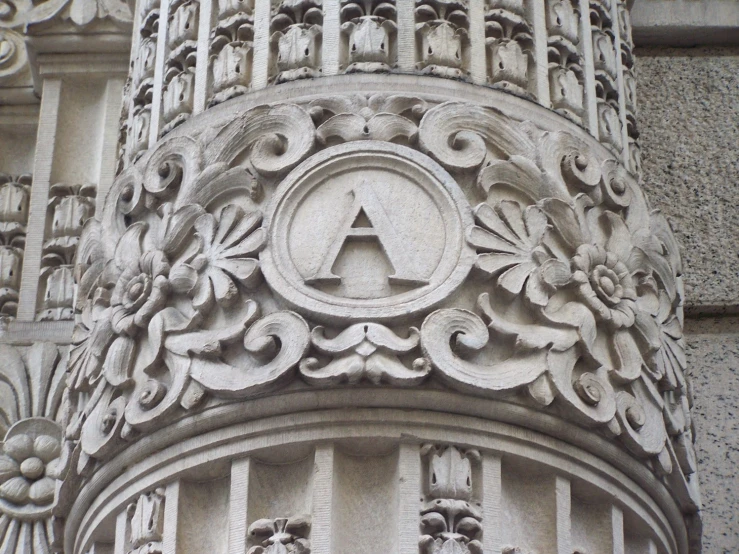 a ornate architectural stone building with a circular emblem