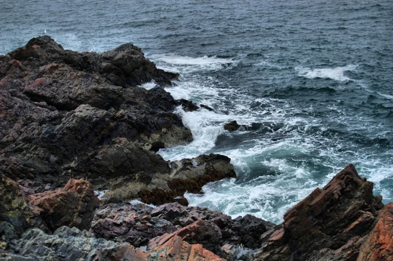 water crashing onto the rocks as it makes it's way up the shore