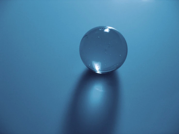 the glass ball is upside down on the surface