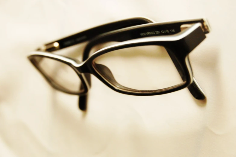 the cat - eye shape glasses have clear, black frames