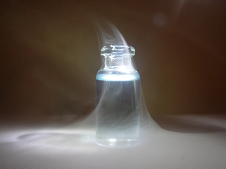an open glass jar containing liquid floating