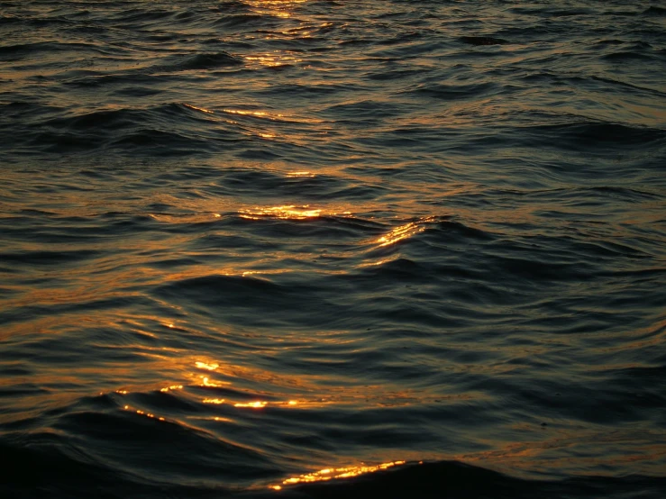 the sun reflecting off the surface of the ocean
