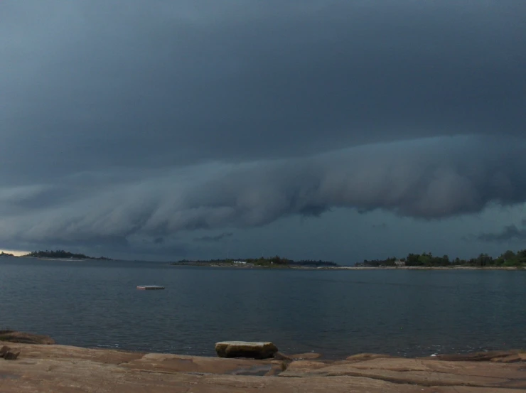 a view of an ocean with storm clouds approaching