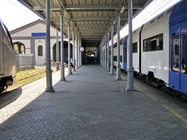 a blue and white train at a station