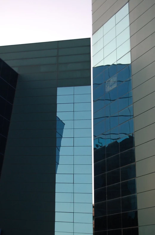 the reflection of a clock and another building on the side