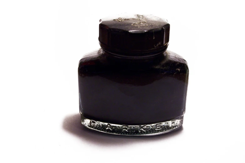 the top of a black bottle with silver accents