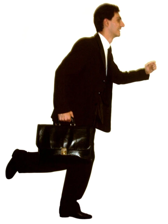 man in business suit and hat carrying a briefcase