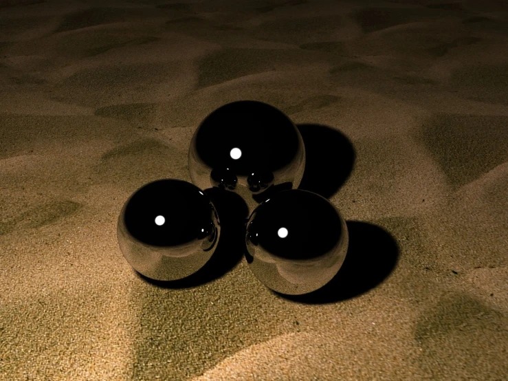 four black balls sitting next to each other on a rug