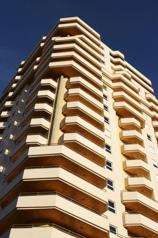 the front of an apartment building with balconies on its sides