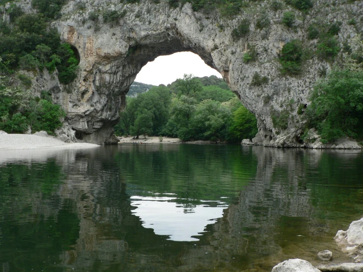 an image of a stone bridge going over a river