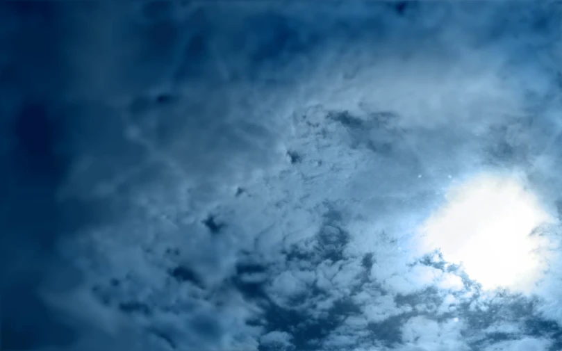 a plane flying through a dark cloudy sky