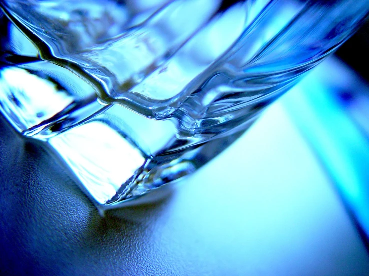 a blue glass sitting on top of a black surface