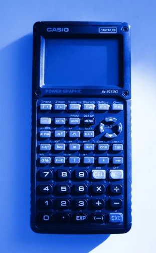 a black calculator sitting on a blue surface