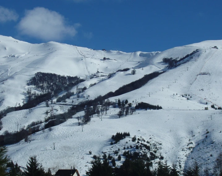 the mountains are covered in snow and trees