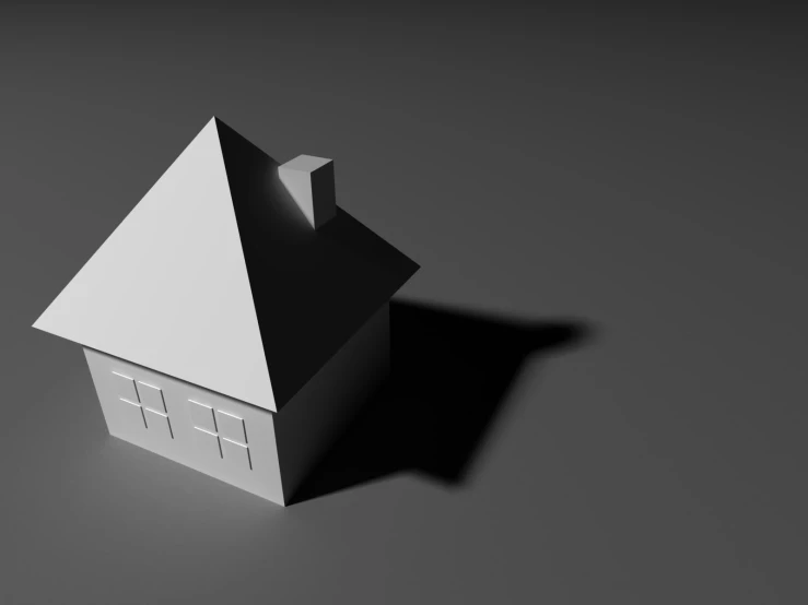 a white and black house sitting on top of a gray surface