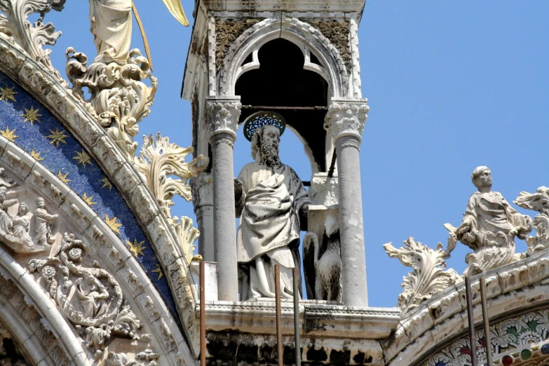 a sculpture is pictured on the top of a large building