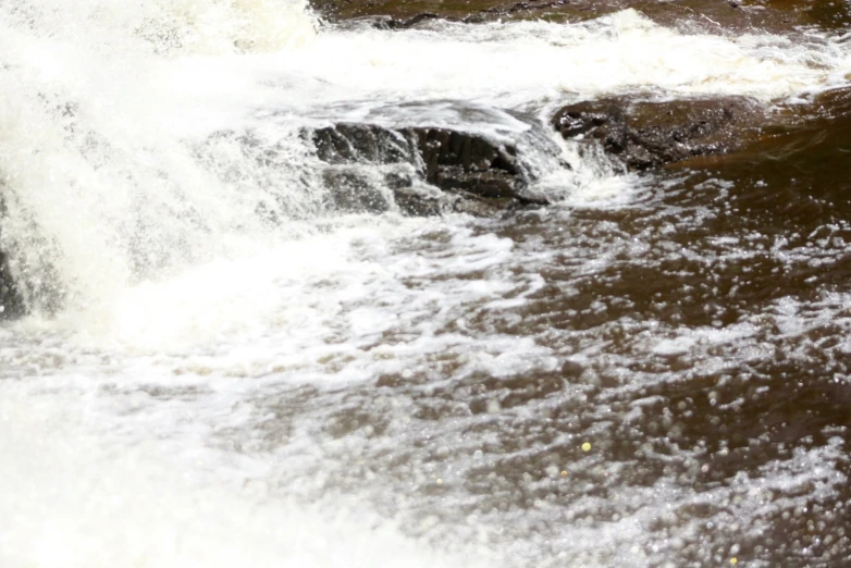 water crashing over and out of a dam