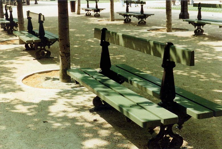 a couple of benches are shown in an open park