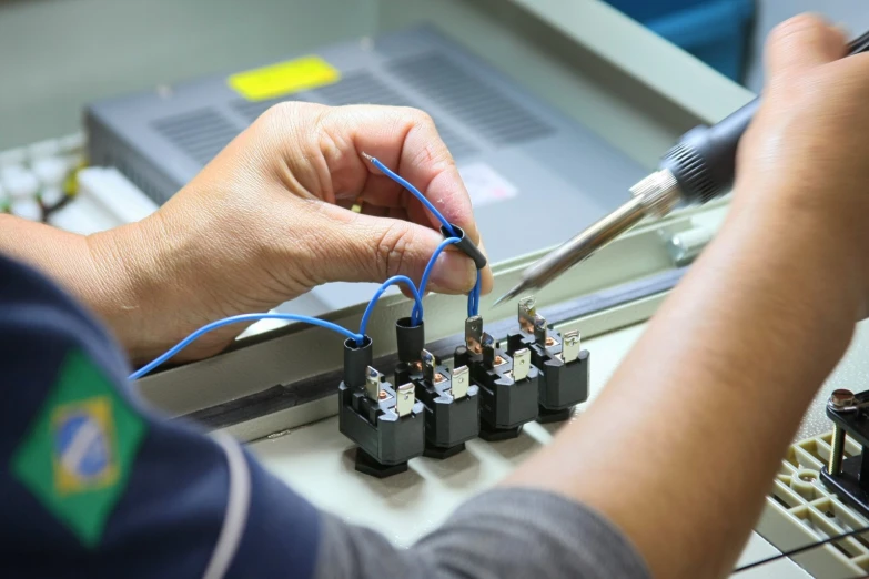 the man is operating a small electrical device