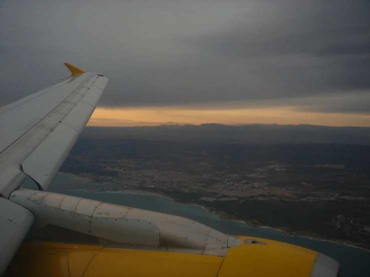 the wing of an airplane with a view of the water