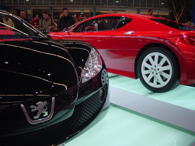 a couple of different cars on display at a car show