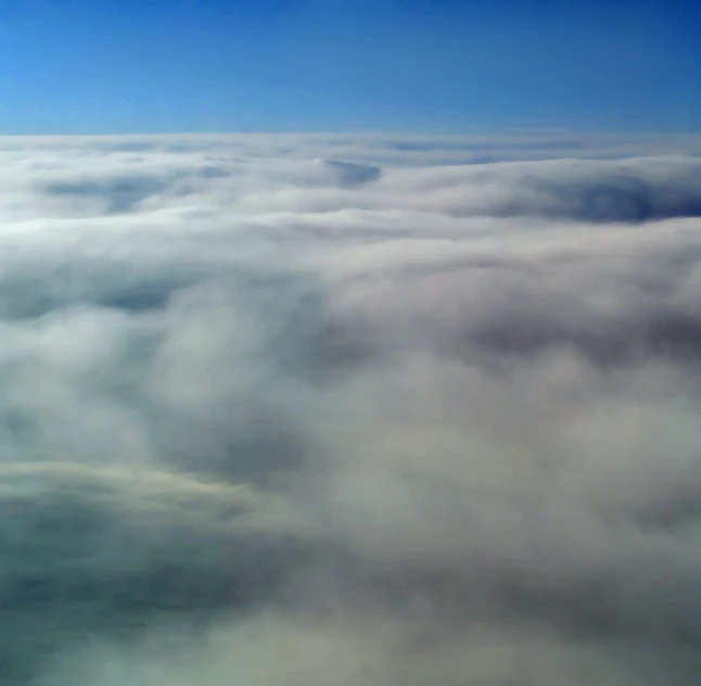 an aerial view of clouds and blue sky from the air