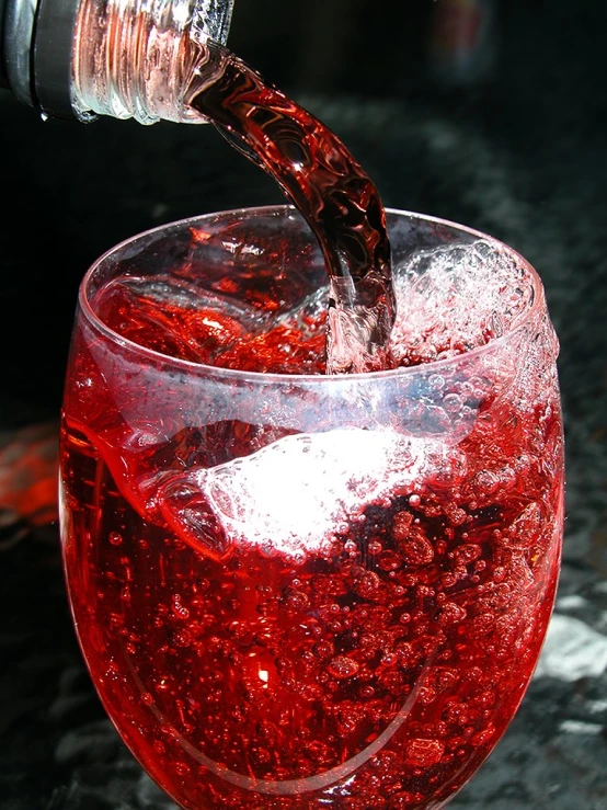 a red liquid poured into a glass